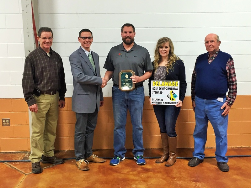 Allen Harim poultry grower Chris Lesniowski, center, and his wife Krista are congratulated by Delaware Nutrient Program Manager Chris Brosch. Also pictured are Ed Jewell, left, Allen Harim housing manager; and Bill Vanderwende, right, chairman of the Nutrient Management Commission. SOURCE SUBMITTED